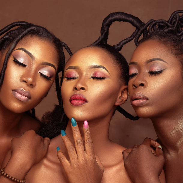 Three luminous black women leaning towards each other with their eyes closed